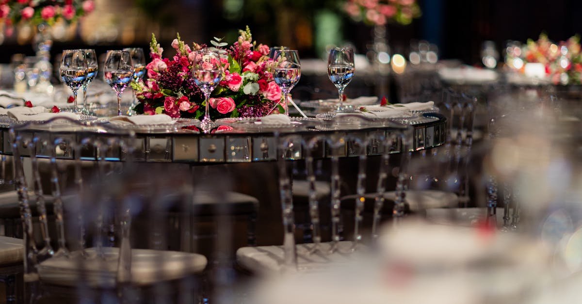 Luxurious wedding reception table setup with pink floral centerpiece and glassware.