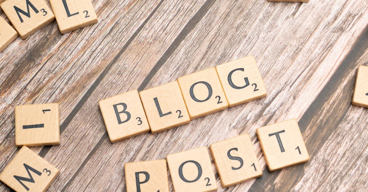 Wooden letter tiles spelling 'Blog Post' on a wooden background, ideal for online media concepts.